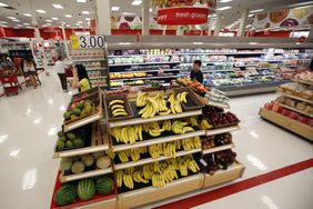 Shoppers walk through the produce section at Target. 