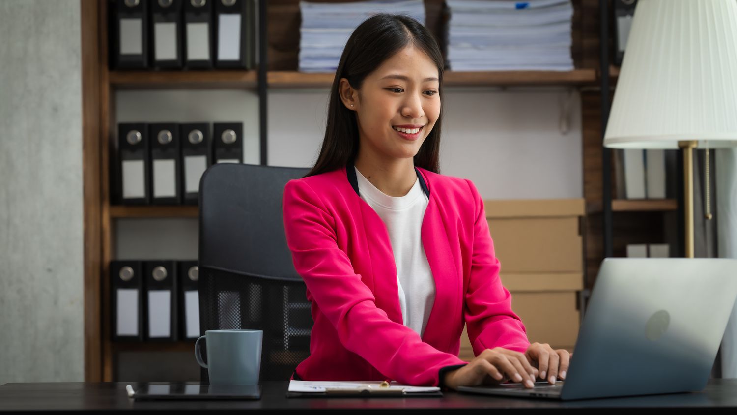 Young woman in an office on a laptop