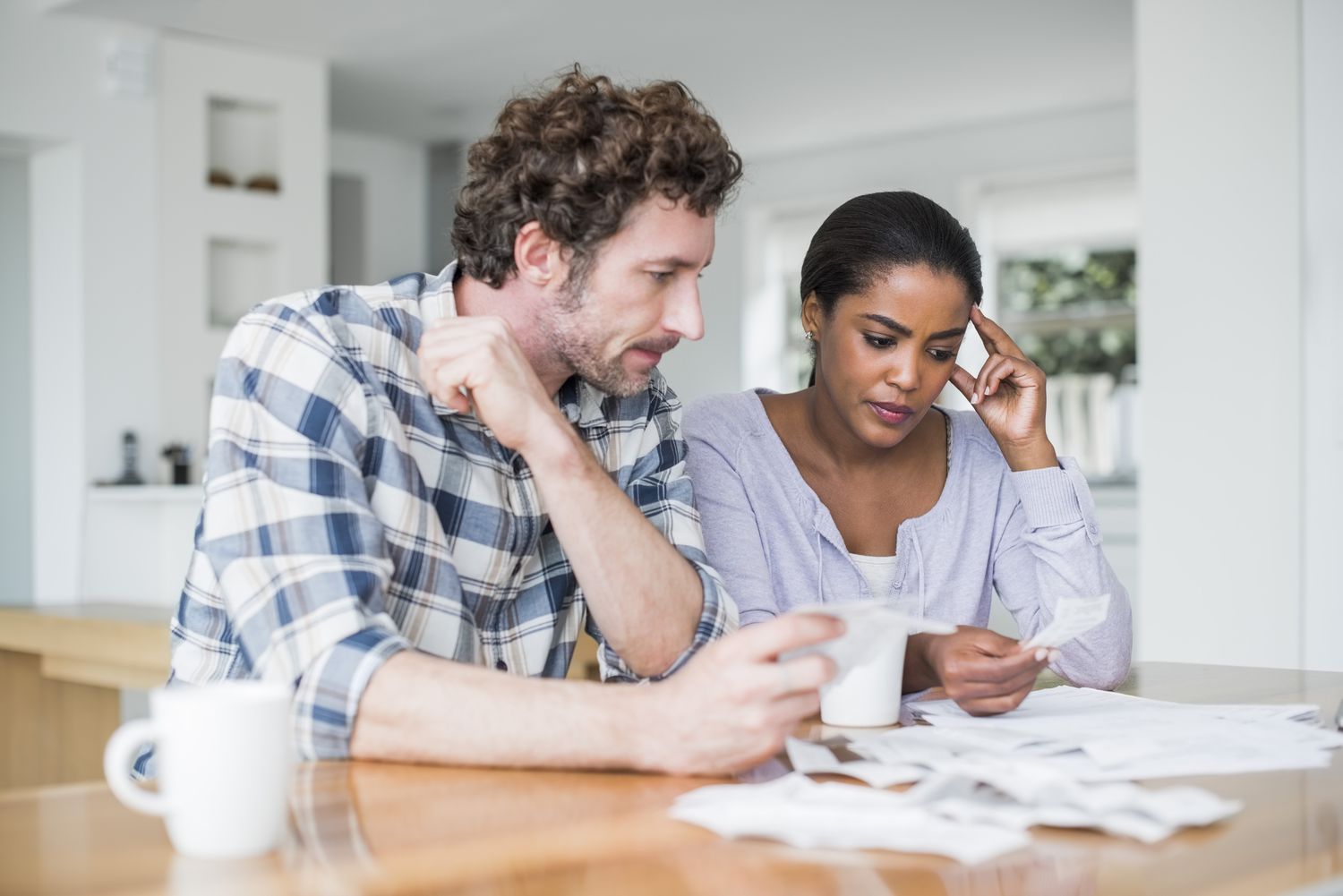 Tensed couple reading bills