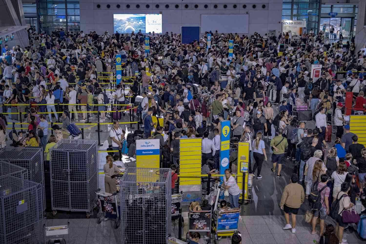 Crowds gather at an airport in Manila, Philippines, as a global outage impacted flights around the world.