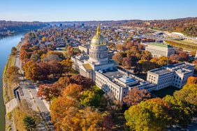 An aerial view of the West Virginia State Capitol Building and downtown Charleston with fall foliage.