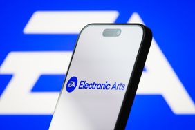 the logo of Electronic Arts Inc. is displayed on a smartphone screen, with the company's iconic EA branding visible in the background