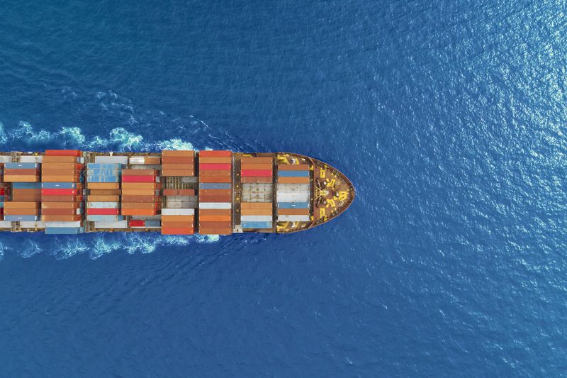 aerial top view container ship runing have wave in green sea, bangkok, thailand.