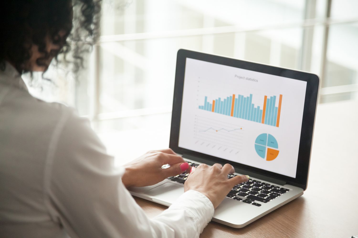 A woman examining statistics on a laptop