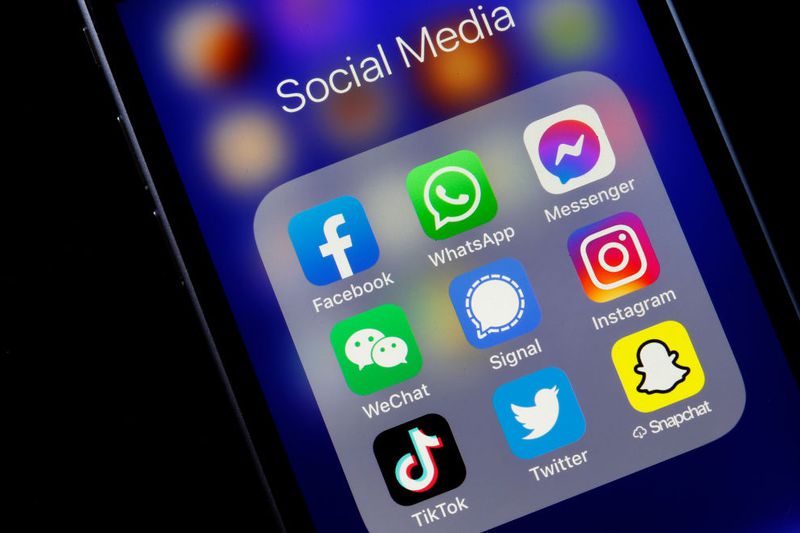 Closeup of a smartphone showing social media icons.