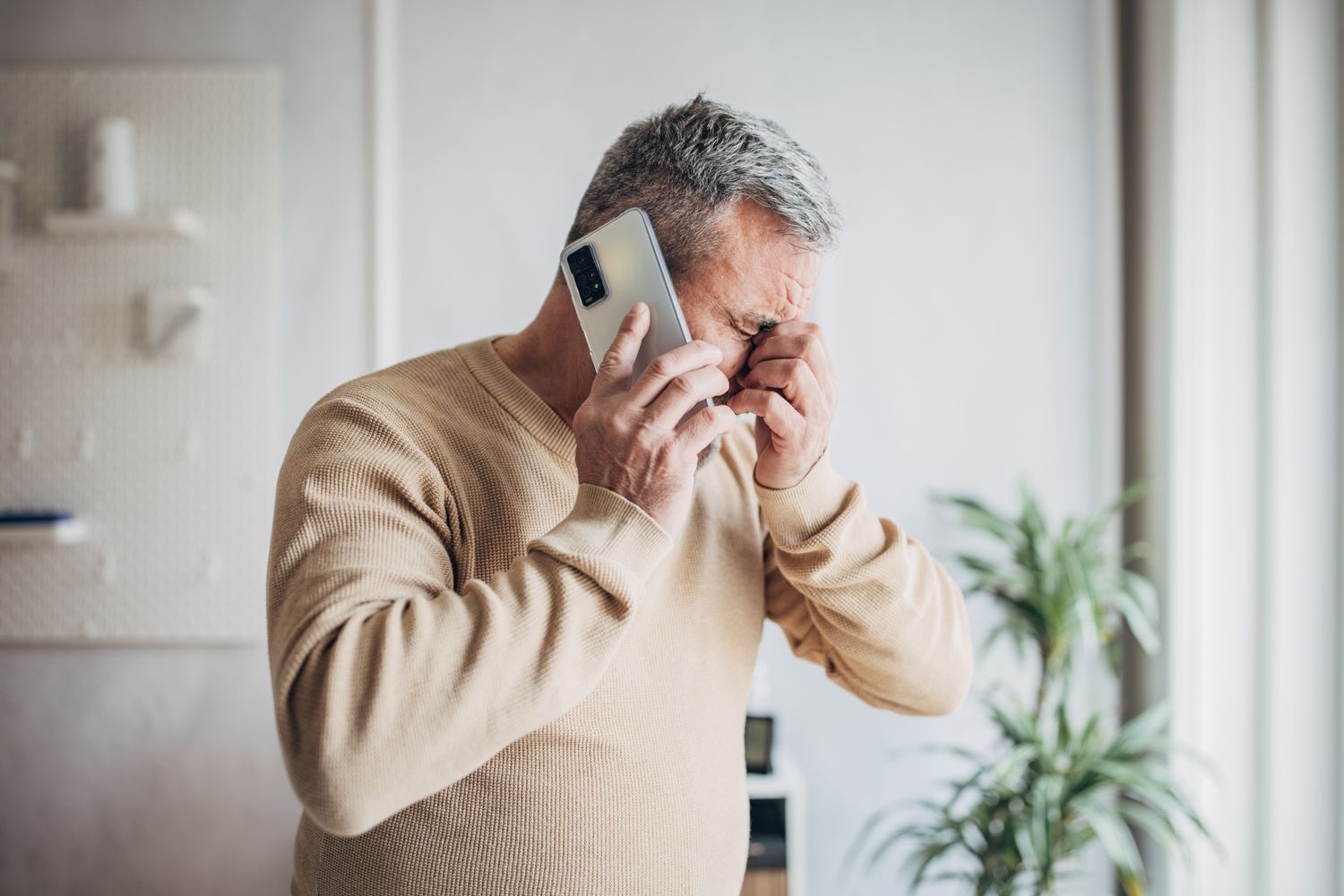 Worried businessman talking using mobile phone