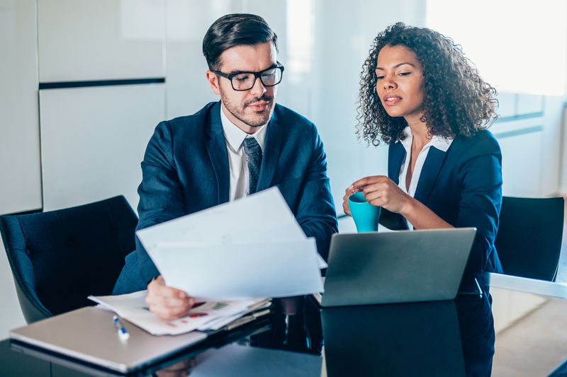 Businesspeople reviewing forms in an office