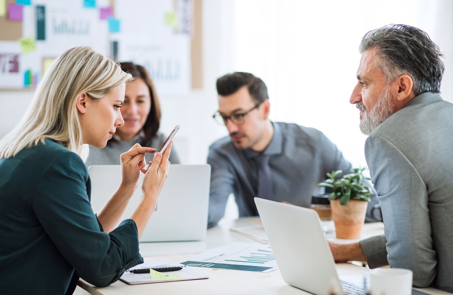 Businesspeople Sitting Around the Desk in an Office, Having Meeting