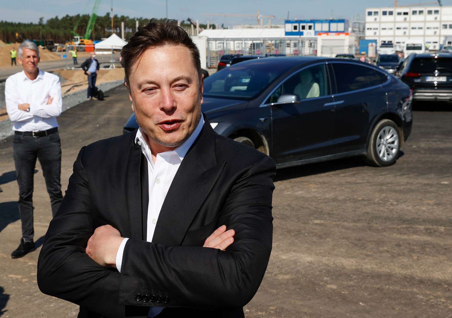 Tesla CEO Elon Musk talks to media as he arrives to visit the construction site of the future US electric car giant Tesla, on September 03, 2020 in Gruenheide near Berlin