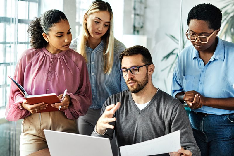 Group of people in an office discussing about company's accounts