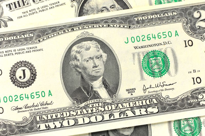 A close-up of a U.S. two-dollar bill featuring a portrait of Thomas Jefferson