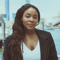 Nafeesah Allen in white shirt with black jacket