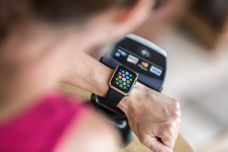 Woman Paying using Apple Watch and Electronic Reader