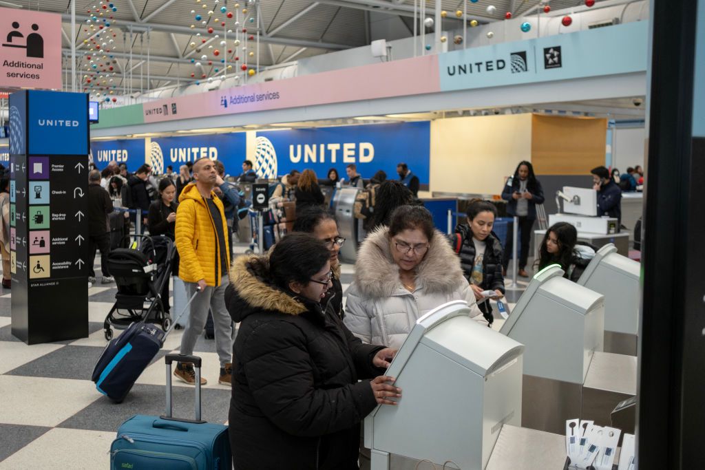 Travelers look for boarding passes and enter the security checkpoint at Terminal 1 of O'Hare Airport on January 12, 2024 in Chicago, Illinois.