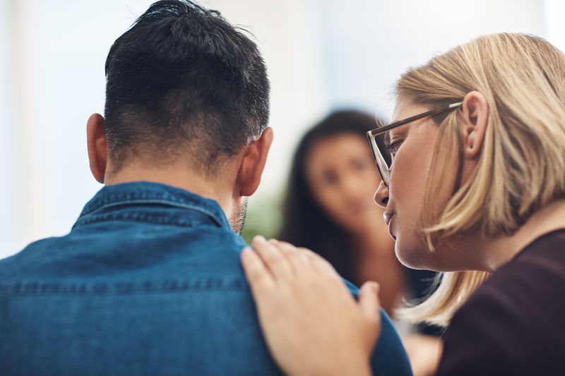 Two people comforting one another in a sad situation