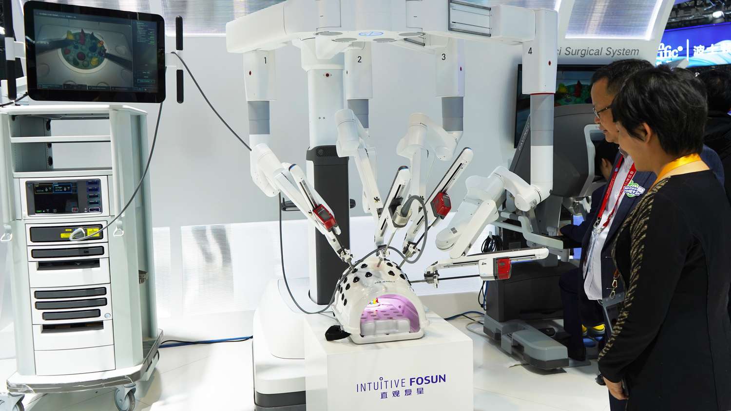 Visitors look at a surgical robot at the booth of IntuitiveFosun at the 6th China International Import Expo CIIE in east China's Shanghai