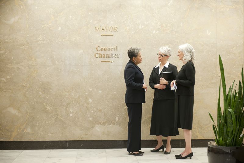 Businesswomen talking together in office corridor