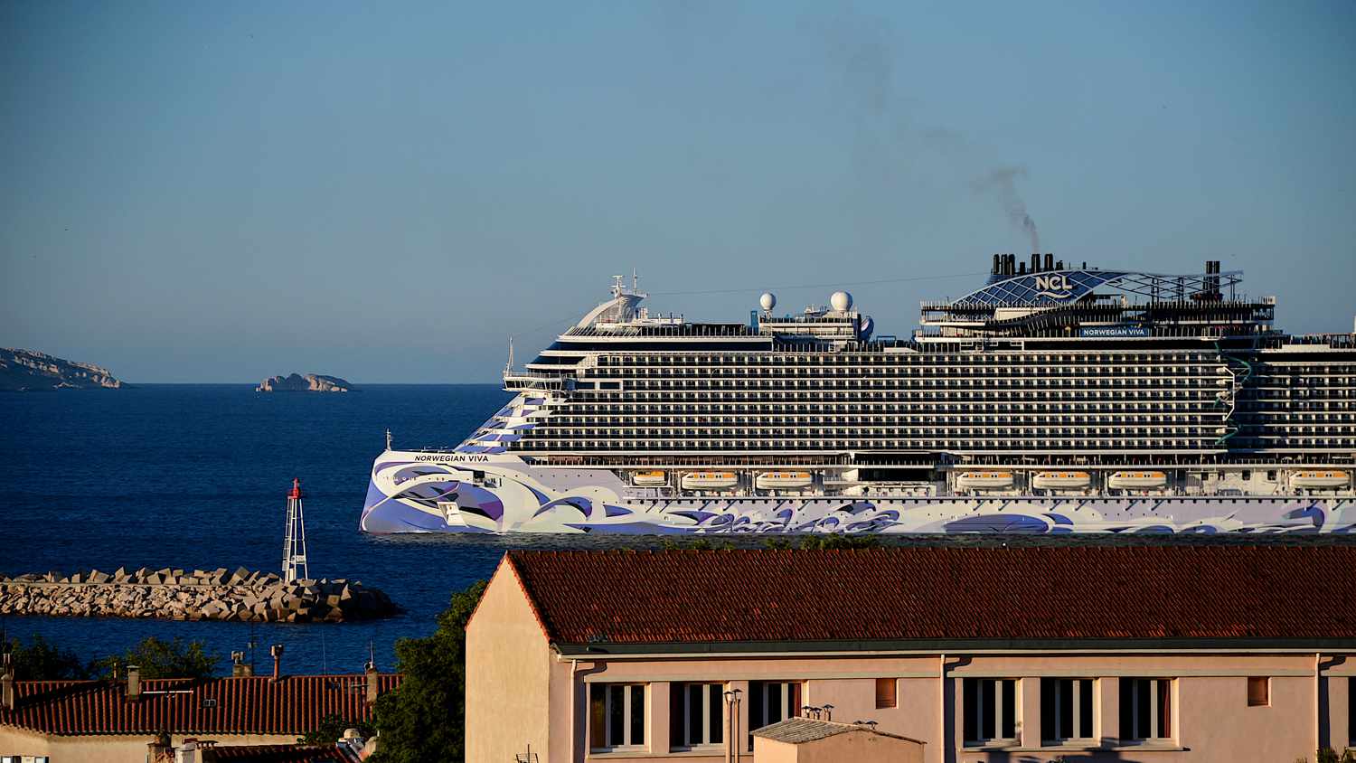 A Norwegian cruise pulls into a port.