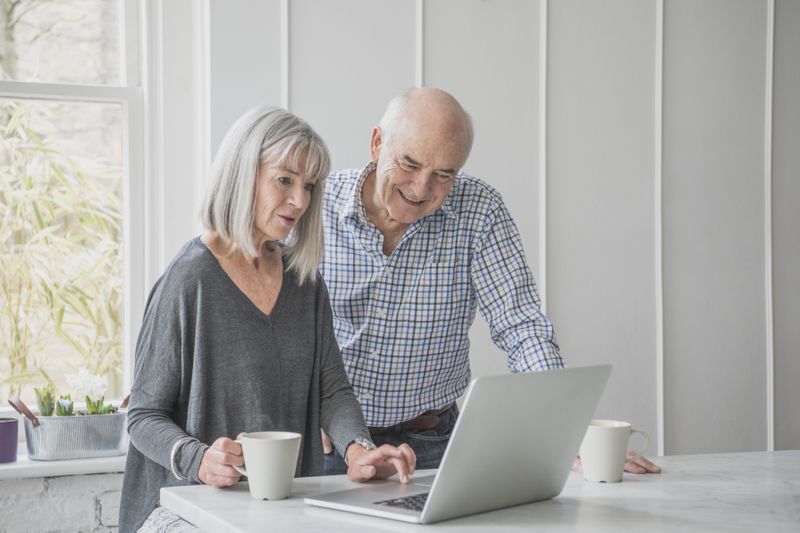 Elderly couple looking at laptop