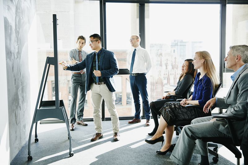 Businessperson presenting ideas at whiteboard
