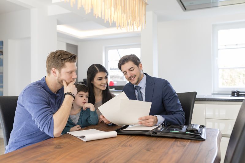 A young family explores adjustable life insurance options with their agent.