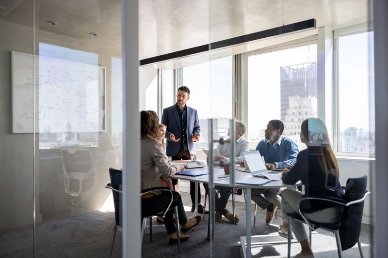 A business meeting in an office with a group of shareholders to agree on course of action 