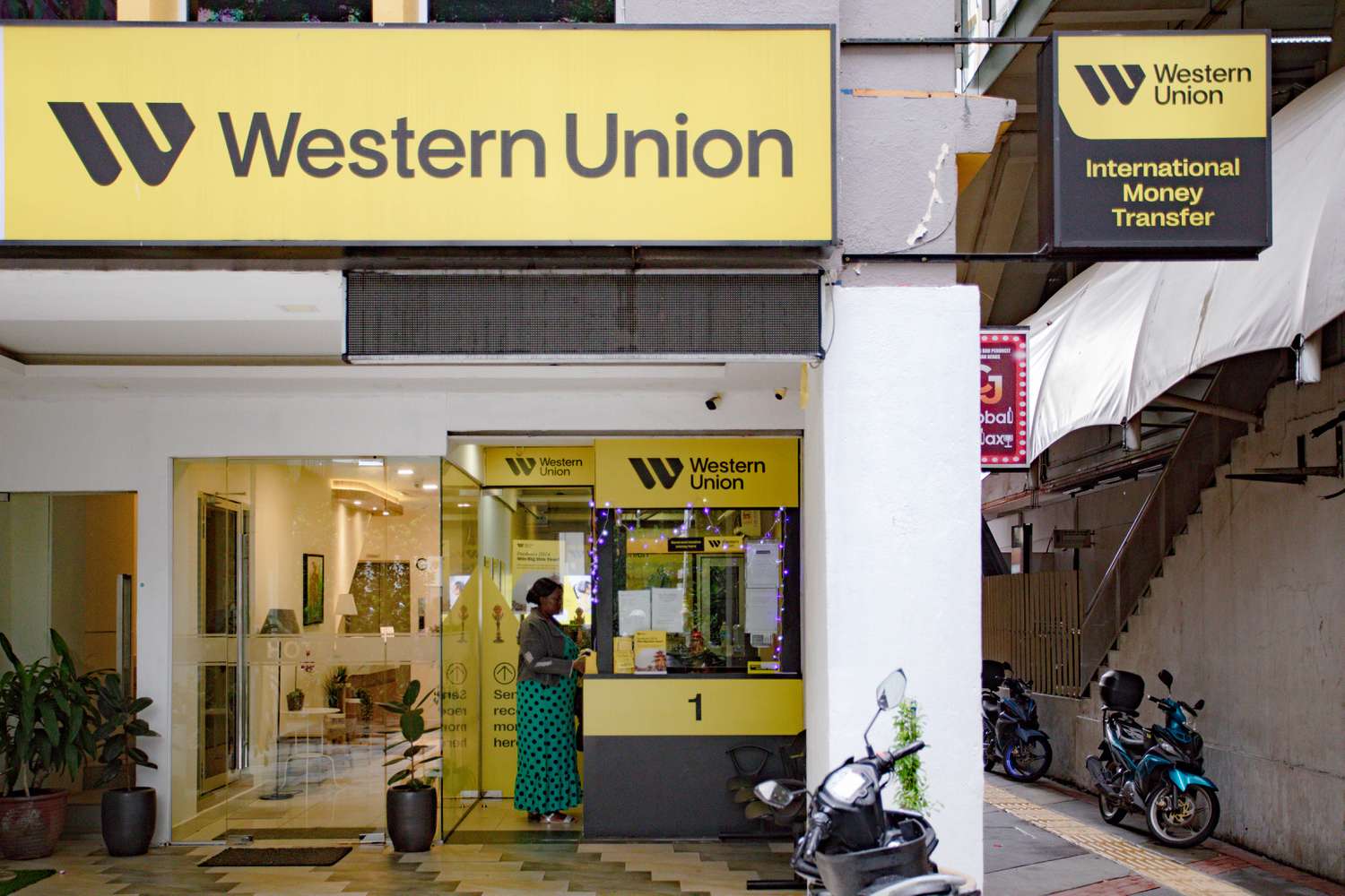 Entrance to a Western Union branch featuring signage for international money transfer services