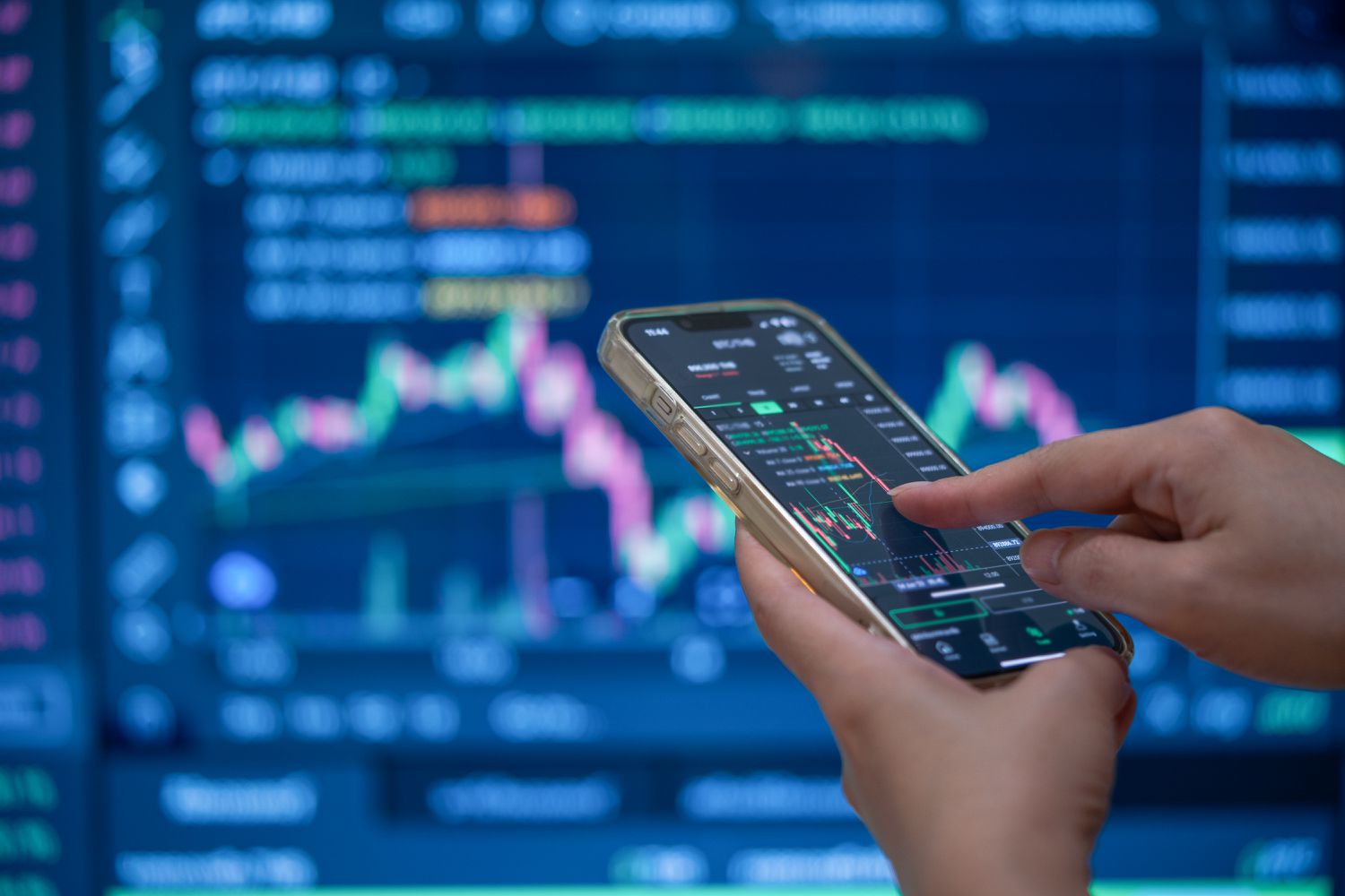 Person using a smart phone analyzing stock data