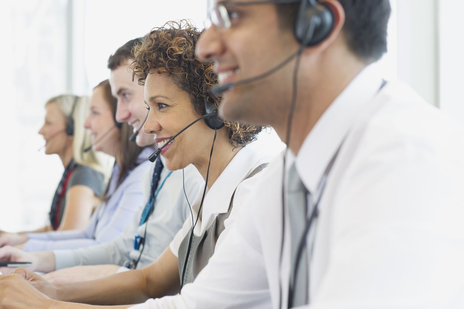 people talking on headsets in a call center