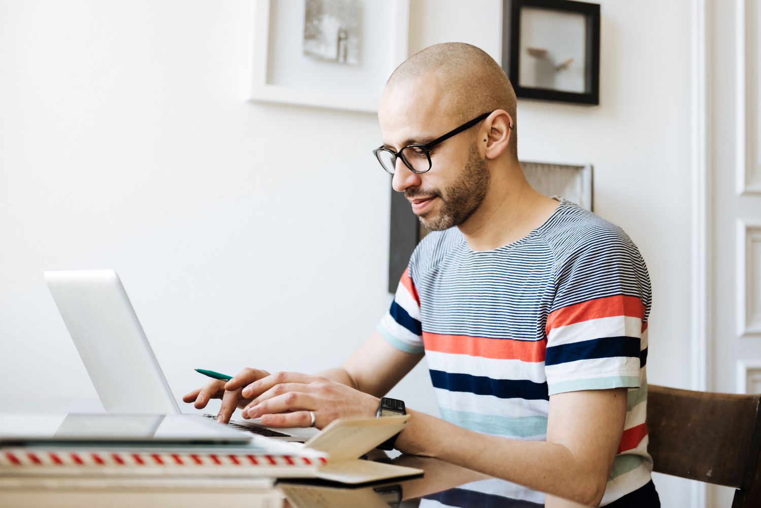 Man works on laptop at home