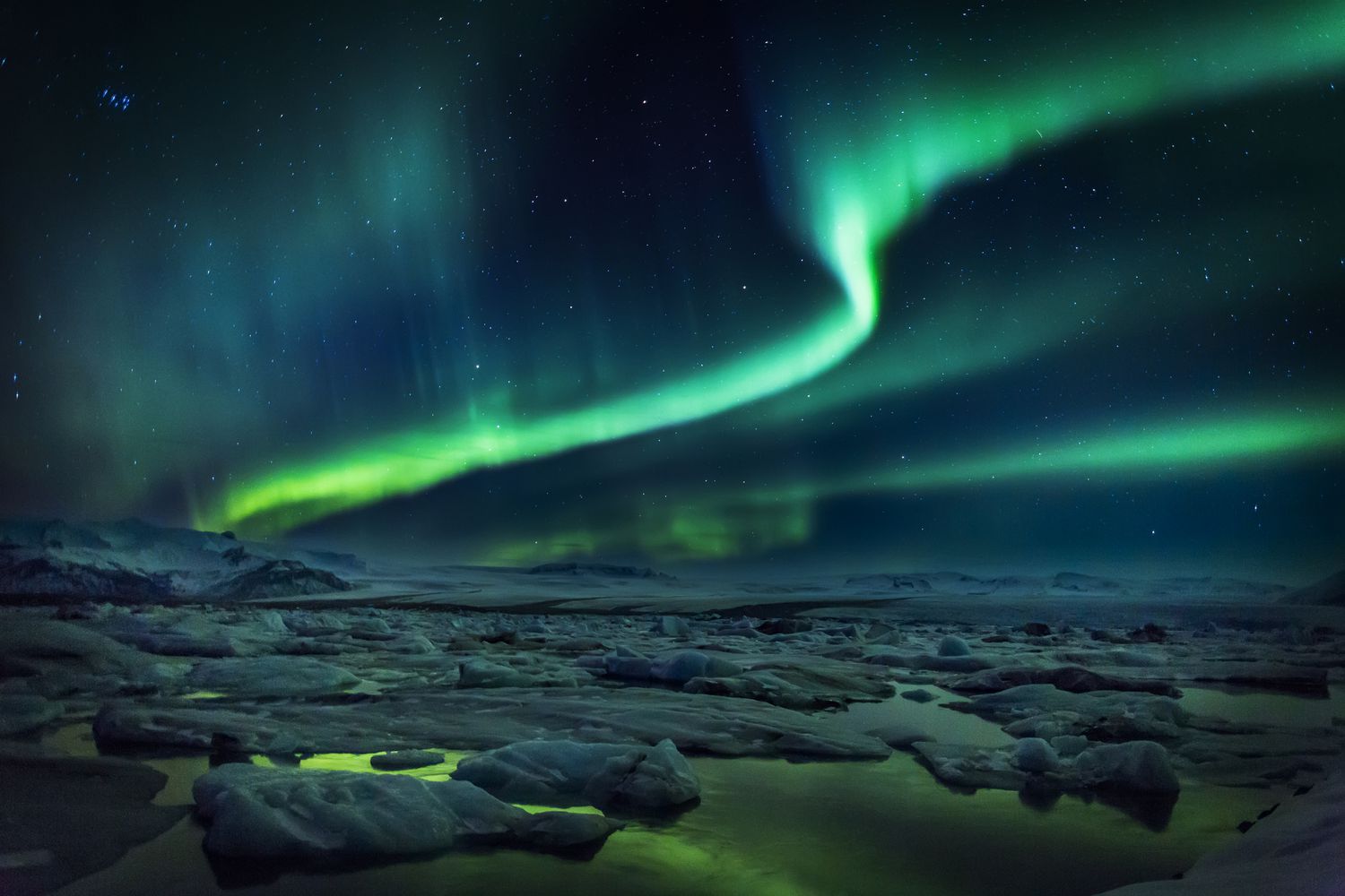 Icebergs with Aurora and reflections, Jokulsarlon Glacial Lagoon, Breidamerkurjokull Glacier, Vatnajokull Ice Cap, Iceland