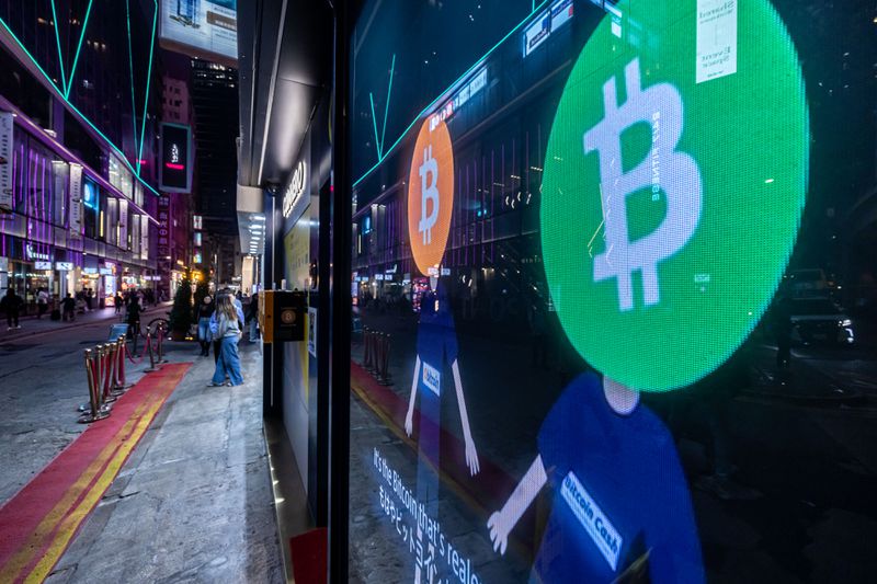 Bitcoin logos on a screen in Hong Kong, China, on Tuesday, Dec. 5, 2023.