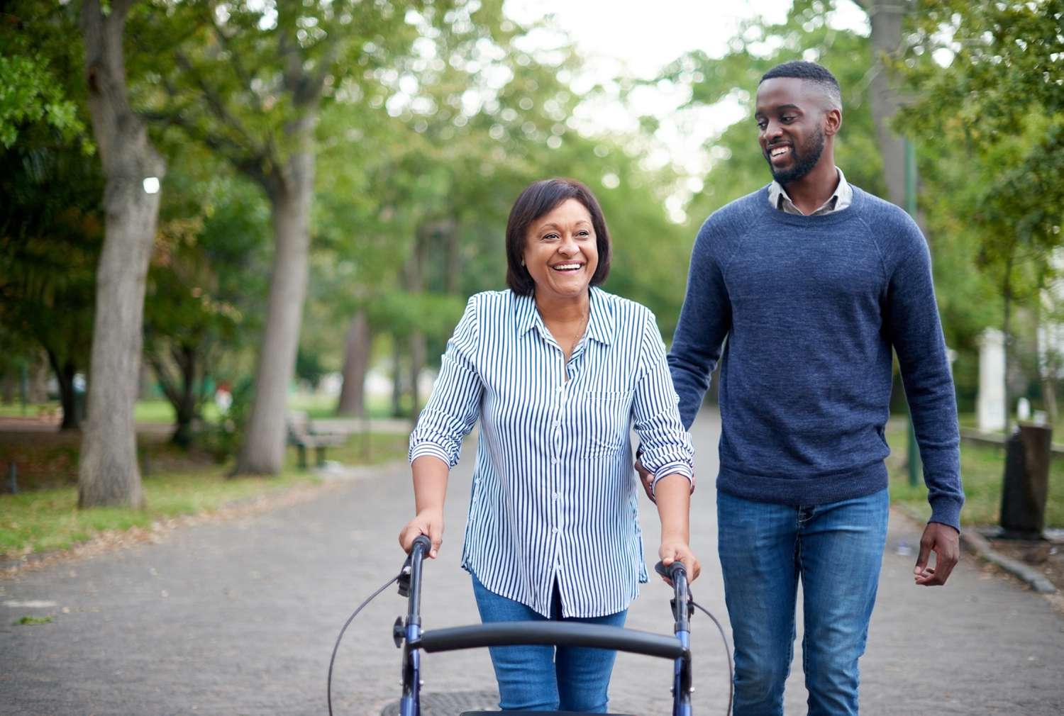 Two people walk in a park