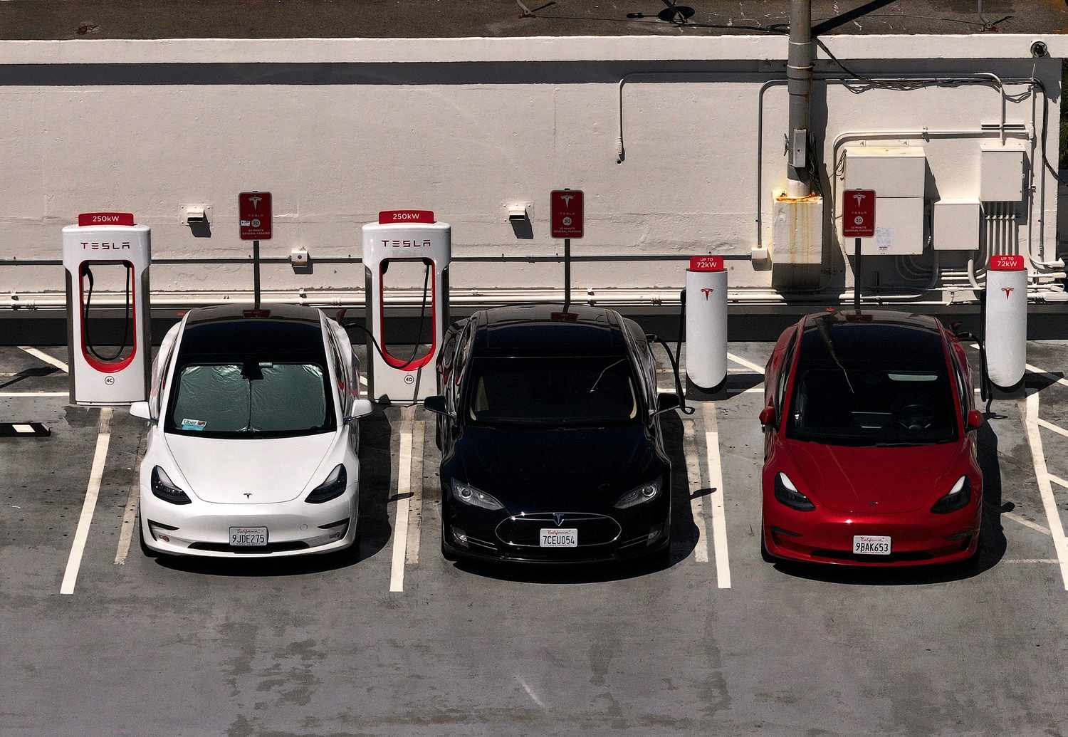 Tesla cars sit parked at a charging station on May 19, 2025 in San Francisco, California