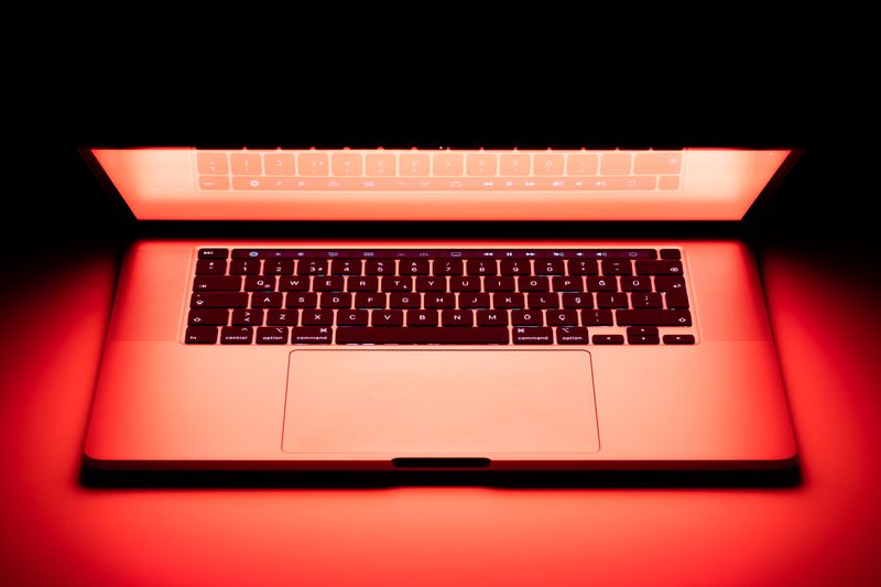 apple macbook laptop in red light