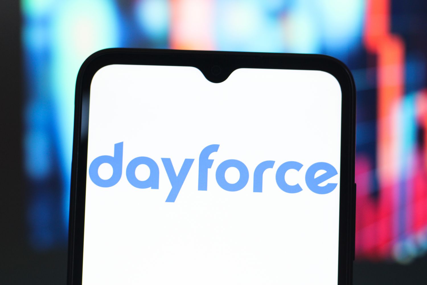 The blue Dayforce logo on a phone screen in front of a blue and red background