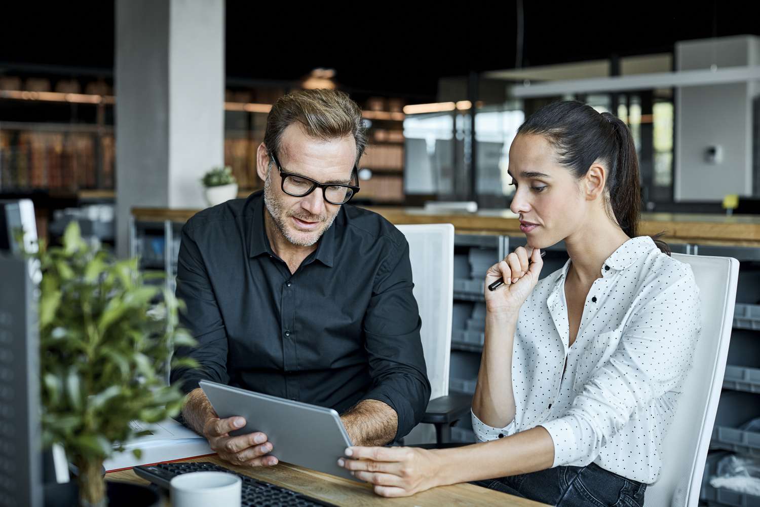 A human resource manager explains the company’s employer-sponsored plan for top level company executives to a new executive.