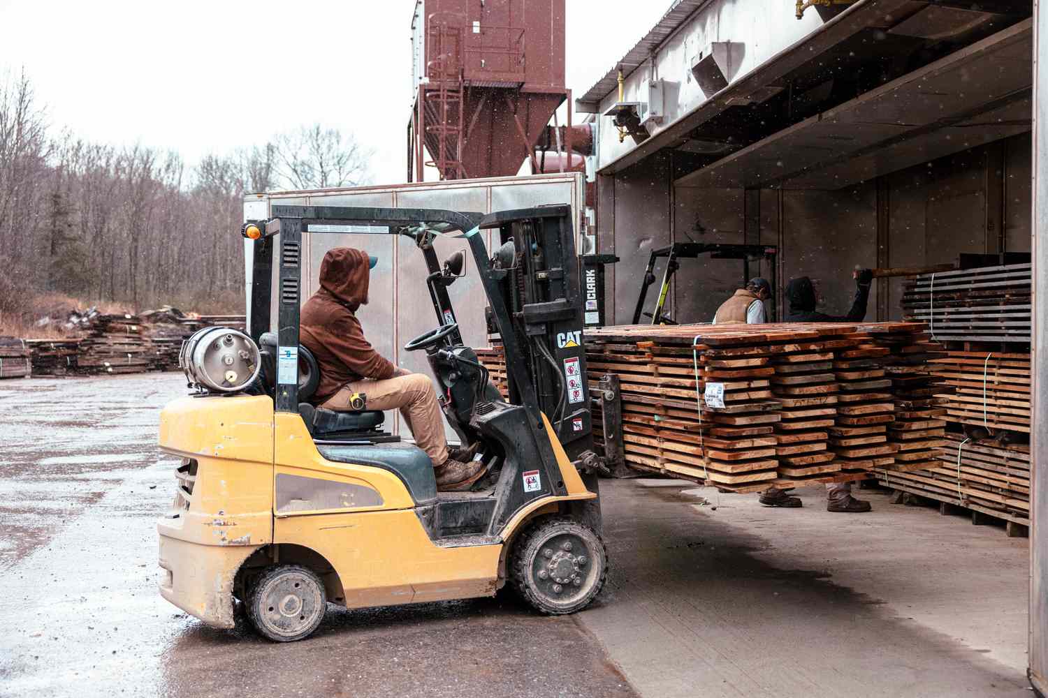 A worker uses a forklift to place planks of wood flooring in a kiln to be dried at The Hudson Company sawmill in Pine Plains, New York, US, on Wednesday, April 10, 2024.