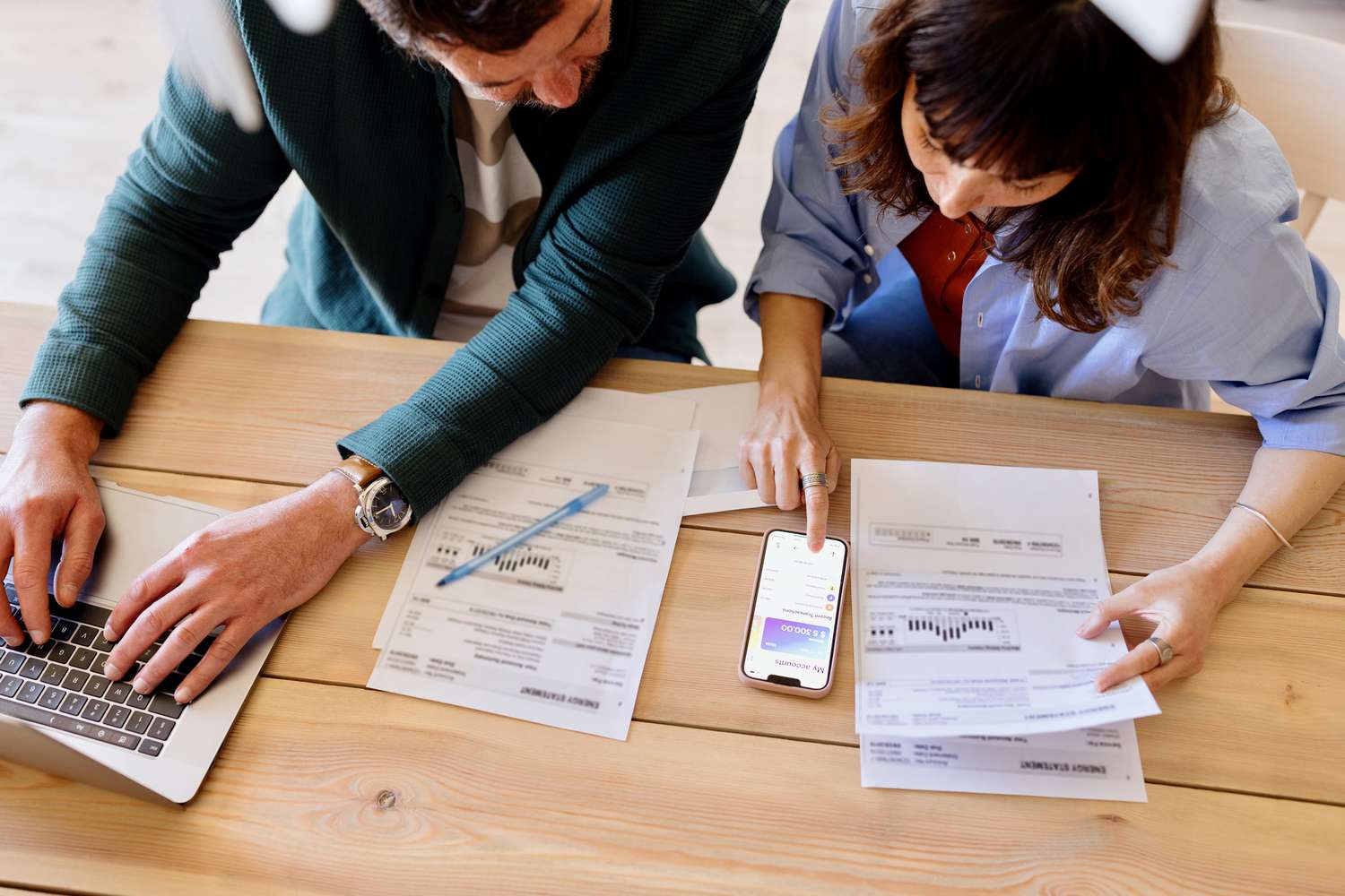 Close-up picture of a couple paying bills from home