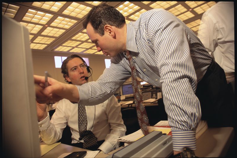 Salomon Brothers Stock Traders Converse at Their Desks