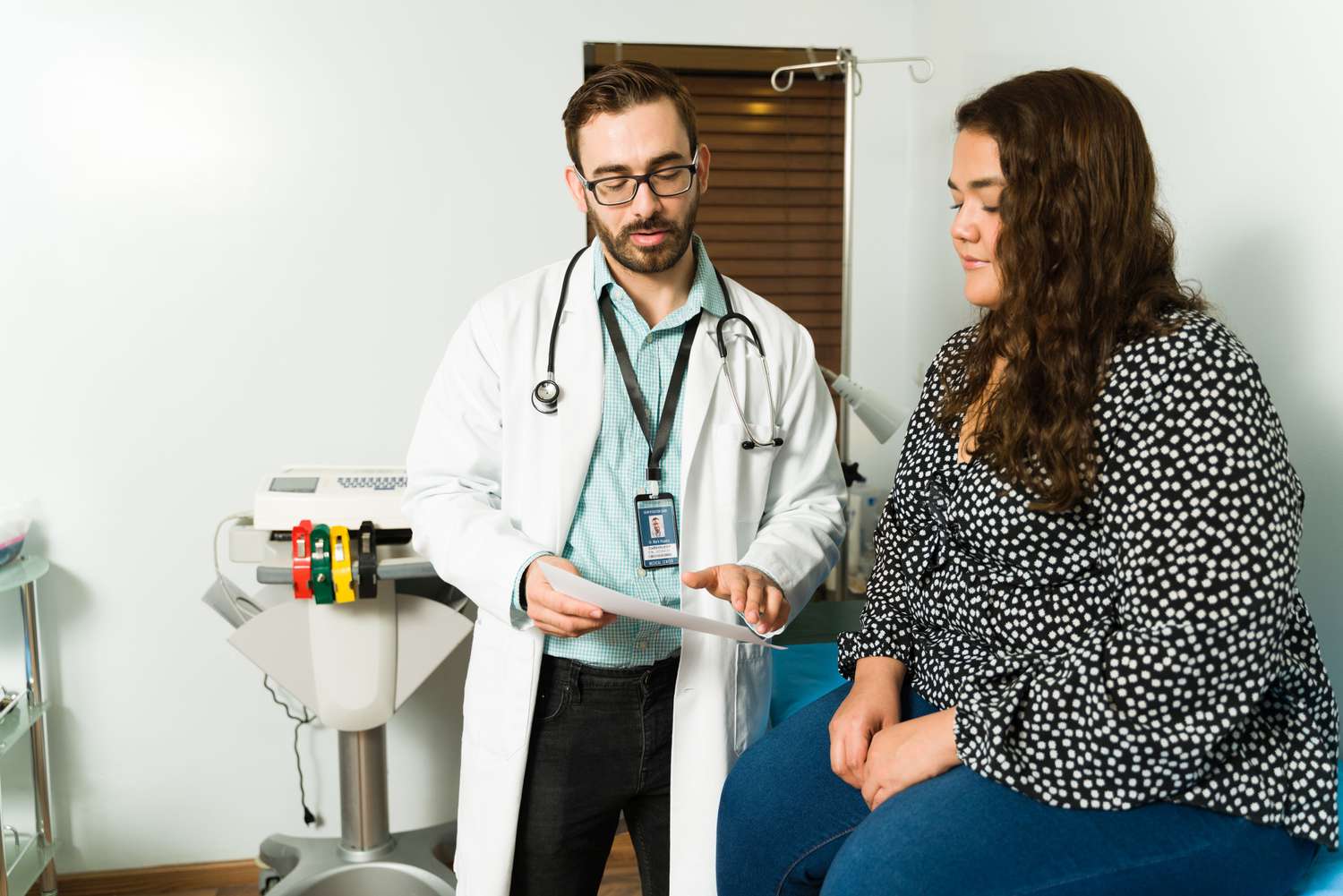 Doctor talking with a patient in an examining room