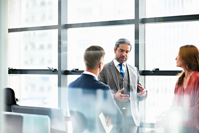 Business People Discussing Plans in Modern Office