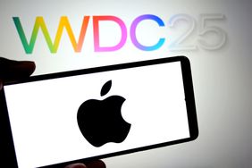 An Apple Logo is seen displayed on a smartphone with a WWDC 2025 logo in the background