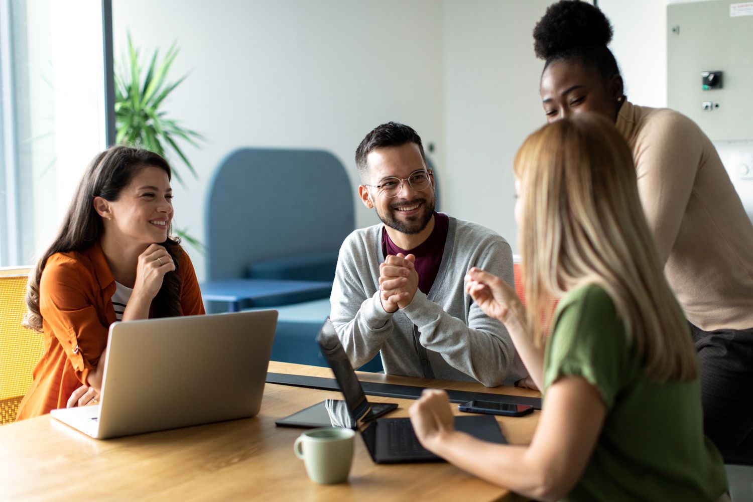 Business team sitting around the table in an office while discussing trends in home equity rates.