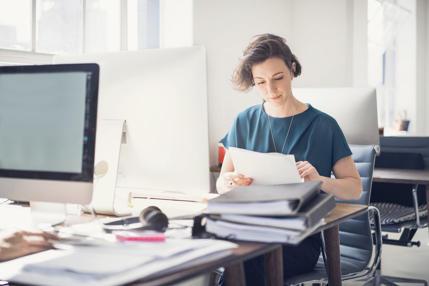 An executive reviews paperwork.