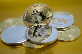 A photoillustration of physical representations of cryptocurrency. 