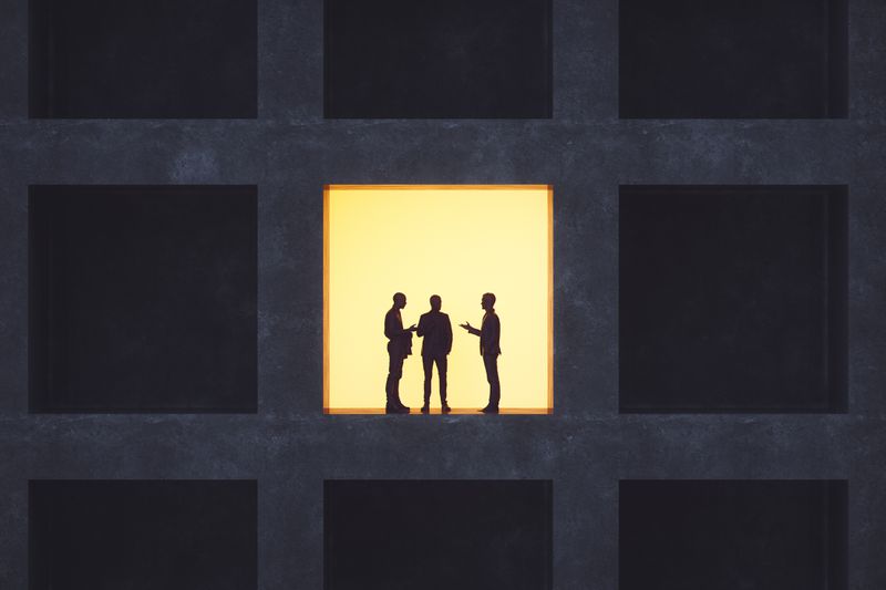 Businessmen talking in secrecy