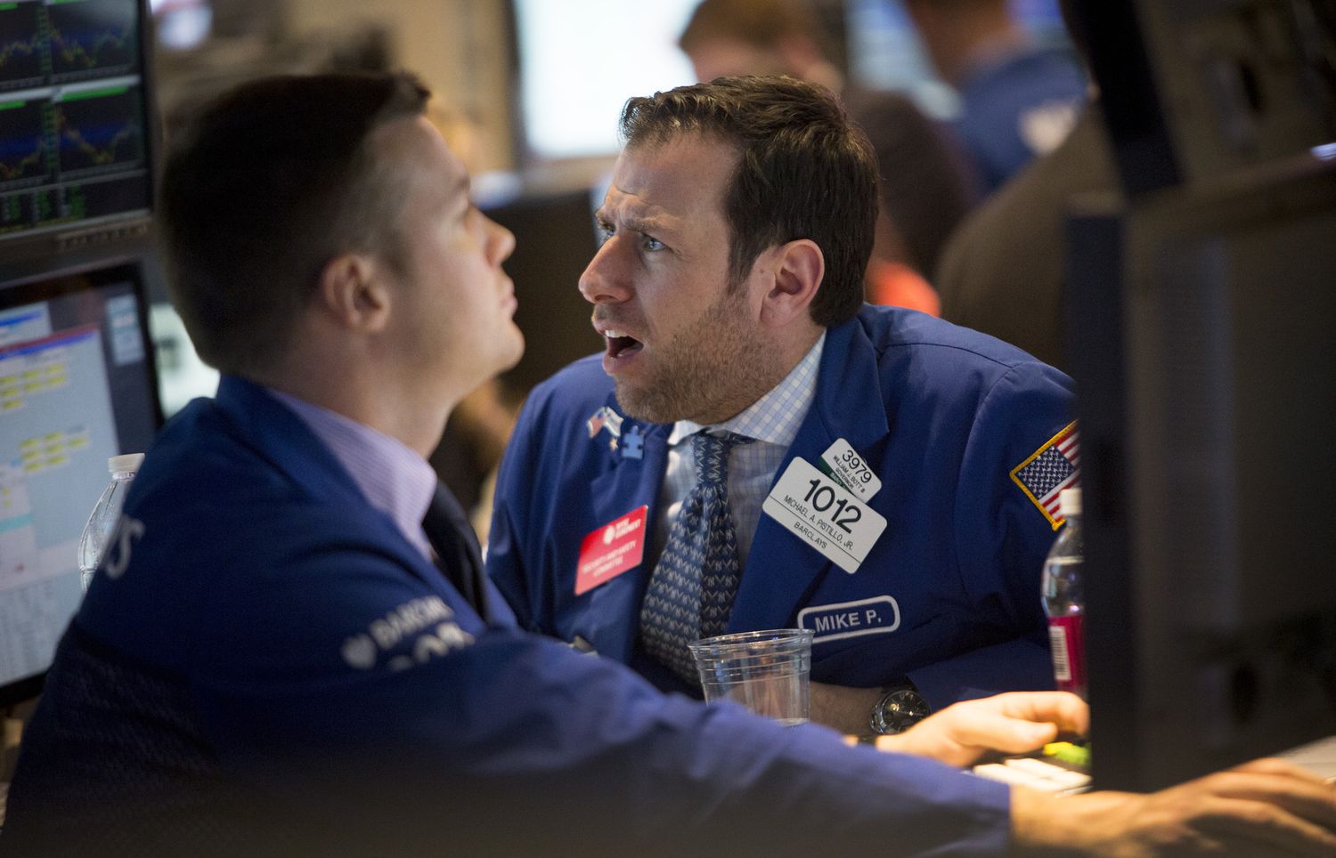 Two traders on the floor of the New York Stock Exchange