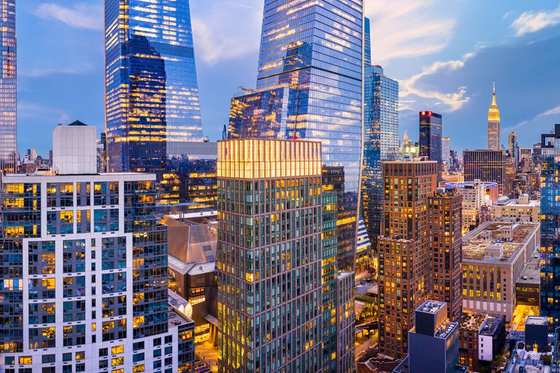 Aerial panorama of New York City skyscrapers at dusk as seen from above the 29th street, close to Hudson Yards and Chelsea neighborhood
