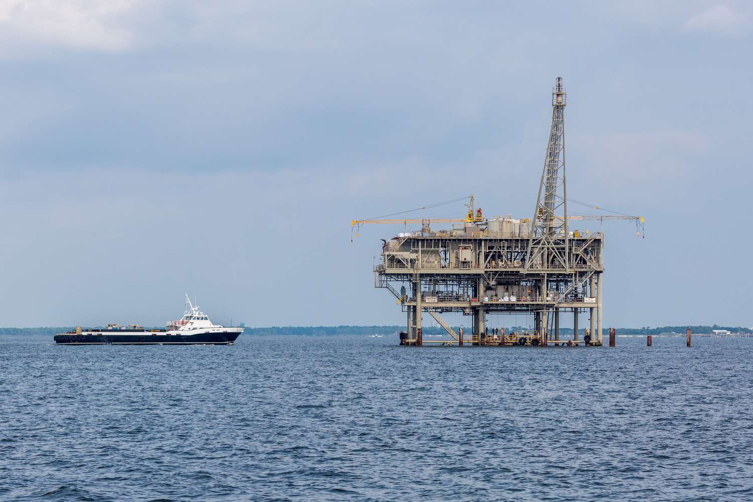 A ship approaches an Exxon Mobil oil rig in the Gulf of Mexico.